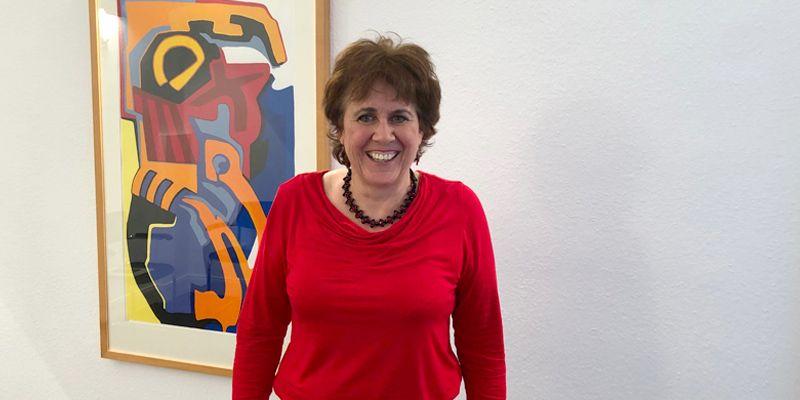Frau Ute Teichert steht vor einer weißen Wand